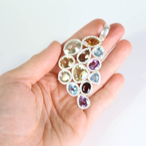 383 - A large modern handmade silver gem-set pendant, vari-cut gemstones include topaz, amethyst, garnet, ... 