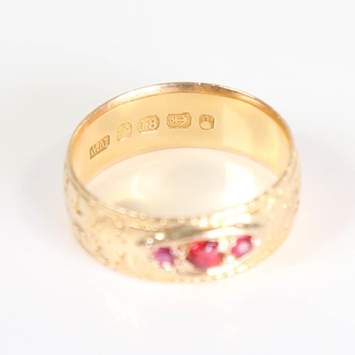 397 - A Victorian 18ct gold 3-stone ruby and garnet band ring, set with round cut gemstones and engraved d... 