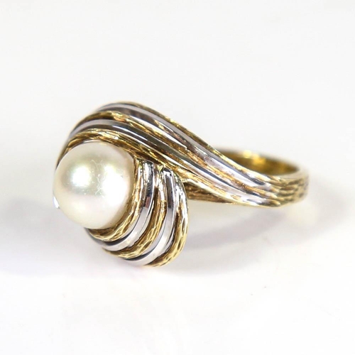 399 - A late 20th century cultured pearl abstract ring, circa 1970s, unmarked openwork textured stylised s... 