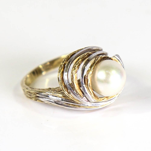 399 - A late 20th century cultured pearl abstract ring, circa 1970s, unmarked openwork textured stylised s... 