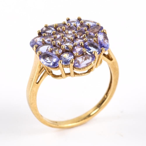 413 - A modern 9ct gold tanzanite cluster ring, set with oval mixed and round cut tanzanites, setting heig... 