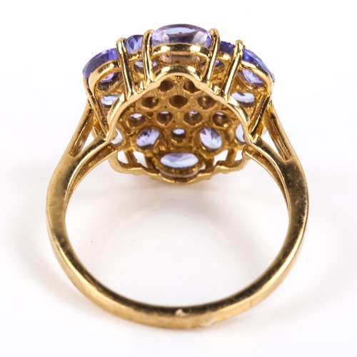 413 - A modern 9ct gold tanzanite cluster ring, set with oval mixed and round cut tanzanites, setting heig... 