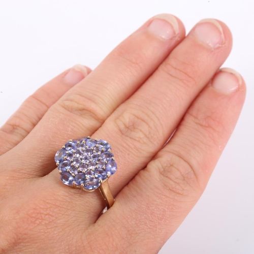 413 - A modern 9ct gold tanzanite cluster ring, set with oval mixed and round cut tanzanites, setting heig... 