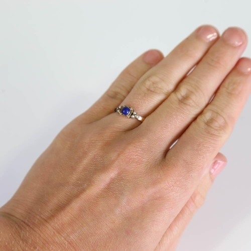 415 - A Georgian lapis lazuli and split pearl ring, set with cabochon lapis within a closed back unmarked ... 