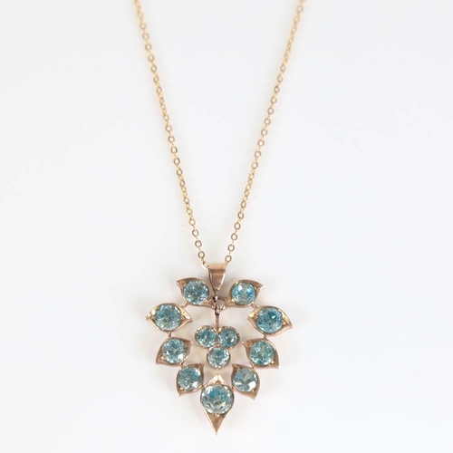 416 - A Middle Eastern blue zircon floral pendant necklace, unmarked yellow metal settings with round cut ... 