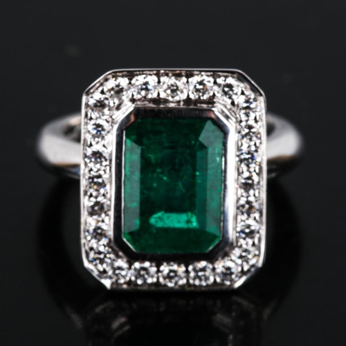 417 - A modern 9ct white gold emerald and diamond cluster panel ring, in Art Deco style, total diamond con... 