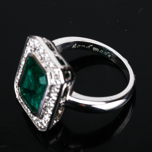 417 - A modern 9ct white gold emerald and diamond cluster panel ring, in Art Deco style, total diamond con... 