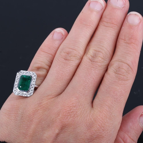 417 - A modern 9ct white gold emerald and diamond cluster panel ring, in Art Deco style, total diamond con... 