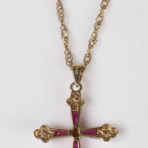 419 - A modern 9ct gold ruby and diamond cross pendant necklace, set with tapered baguette rubies and sing... 