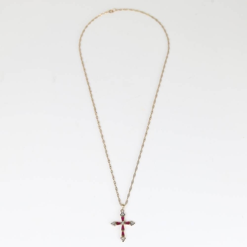 419 - A modern 9ct gold ruby and diamond cross pendant necklace, set with tapered baguette rubies and sing... 