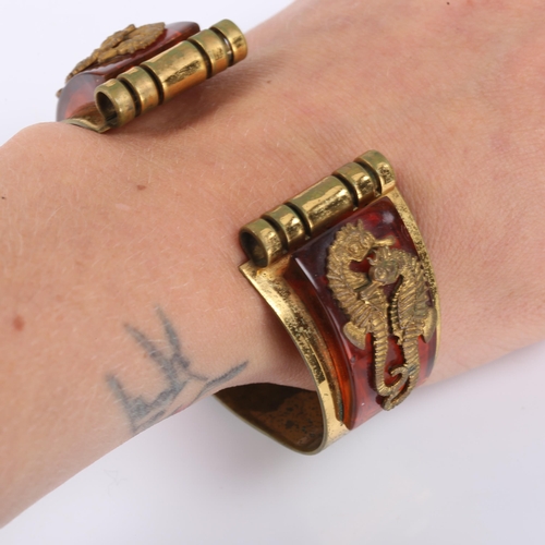 434 - JEAN PAINLEVE - a French Art Deco gilt metal and bakelite Seahorse demi-parure, comprising cuff brac... 