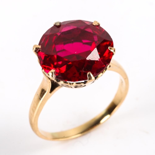 440 - A late 20th century Middle Eastern 14ct gold synthetic ruby dress ring, claw set with large round cu... 