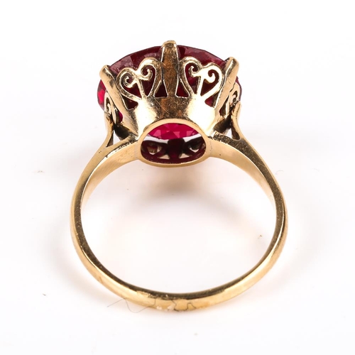 440 - A late 20th century Middle Eastern 14ct gold synthetic ruby dress ring, claw set with large round cu... 