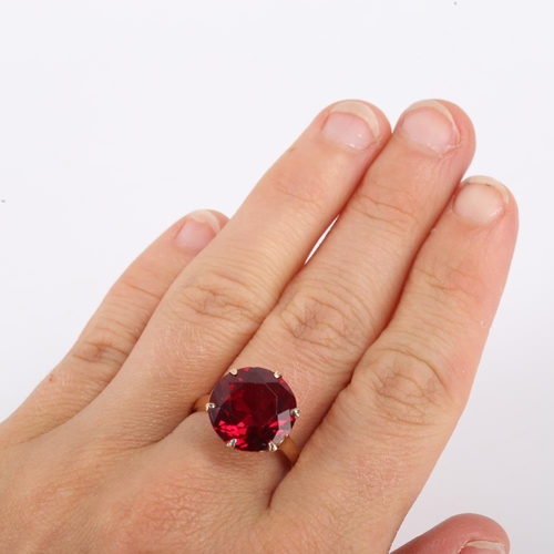 440 - A late 20th century Middle Eastern 14ct gold synthetic ruby dress ring, claw set with large round cu... 