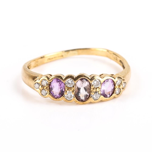 445 - A modern 9ct gold amethyst and diamond dress ring, set with oval mixed cut amethysts and modern roun... 