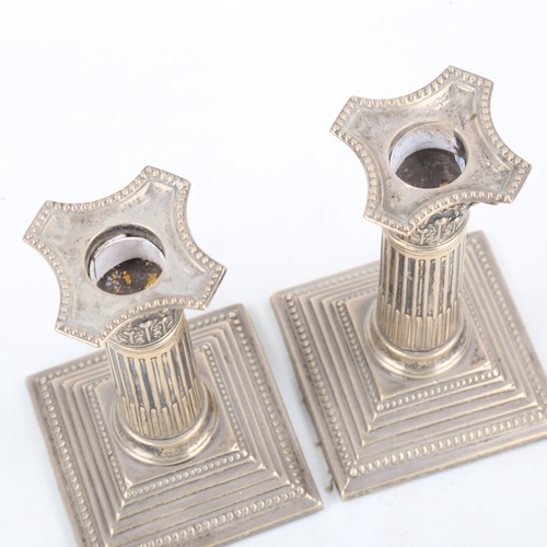 453 - A pair of Edwardian silver Corinthian column table candlesticks, with removable sconces, by James Ch... 