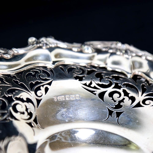 455 - A George V silver cake basket, relief cast foliate border with pierced decoration and scrolled shell... 