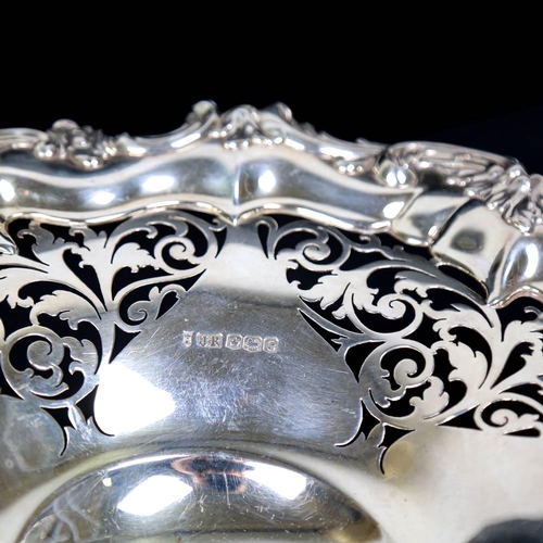 455 - A George V silver cake basket, relief cast foliate border with pierced decoration and scrolled shell... 