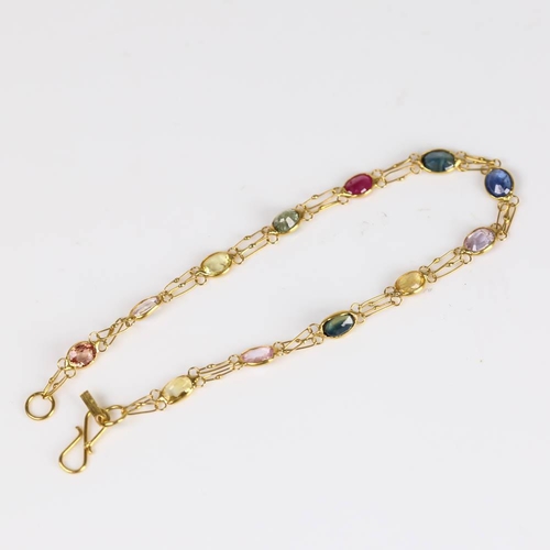 619 - A modern handmade 14ct gold vari-hue sapphire line bracelet, set with oval mixed cut sapphires, brac... 