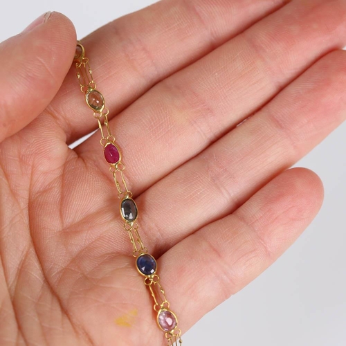 619 - A modern handmade 14ct gold vari-hue sapphire line bracelet, set with oval mixed cut sapphires, brac... 