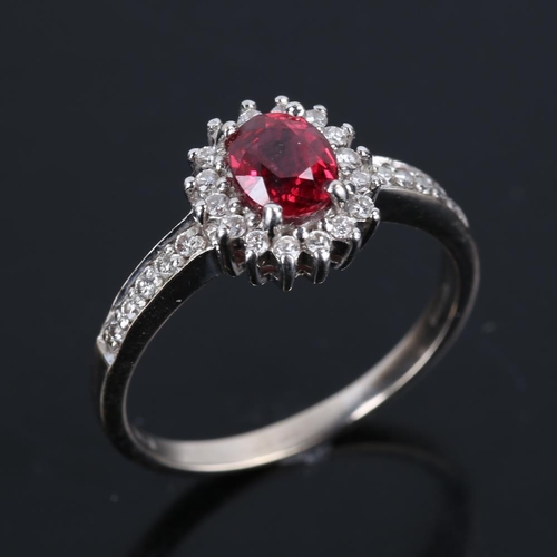 621 - A modern 18ct white gold synthetic ruby and diamond cluster ring, set with oval mixed cut ruby and r... 