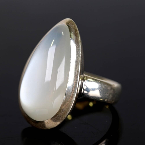 629 - A large modern handmade silver moonstone ring, set with large pear cabochon moonstone, setting heigh... 