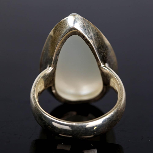 629 - A large modern handmade silver moonstone ring, set with large pear cabochon moonstone, setting heigh... 