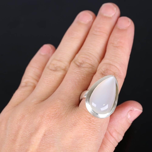 629 - A large modern handmade silver moonstone ring, set with large pear cabochon moonstone, setting heigh... 