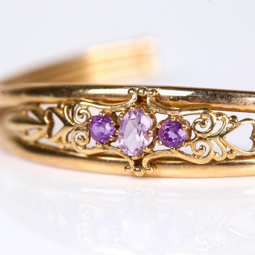 630 - A late 20th century 9ct gold amethyst cuff bracelet, pierced openwork settings with oval mixed and r... 