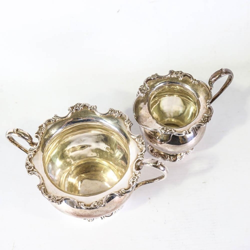 635 - An Edwardian silver matching sugar bowl and cream jug, bulbous form with cast floral rim, by Martin,... 