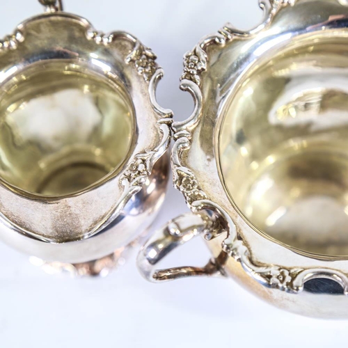 635 - An Edwardian silver matching sugar bowl and cream jug, bulbous form with cast floral rim, by Martin,... 