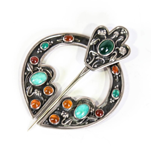 642 - A Scottish Celtic stone set penannular brooch, unmarked white metal settings with cabochon stones an... 