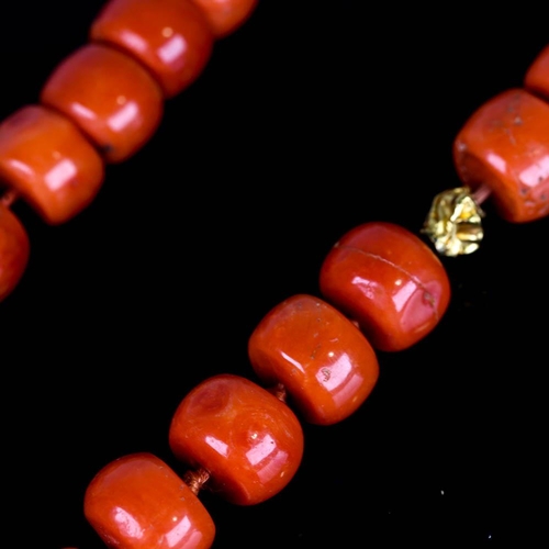 647 - A large graduated single strand polished coral prayer bead necklace, with unmarked high carat gold s... 