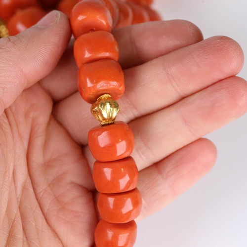 647 - A large graduated single strand polished coral prayer bead necklace, with unmarked high carat gold s... 