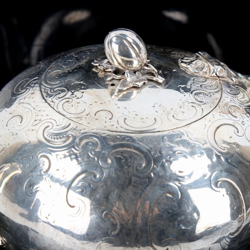 648 - A Victorian silver melon teapot, circular form with engraved foliate decoration, scrolled handle wit... 