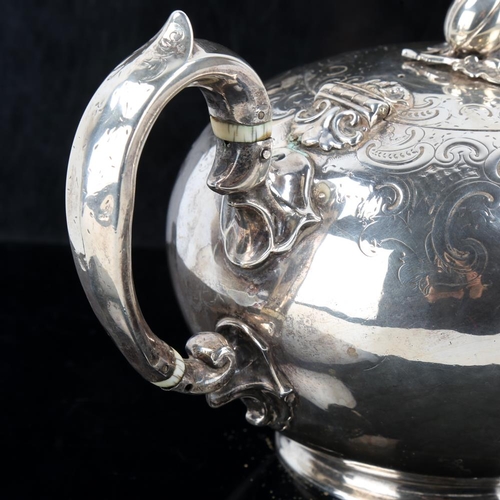 648 - A Victorian silver melon teapot, circular form with engraved foliate decoration, scrolled handle wit... 