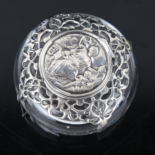 650 - A heavy Victorian silver mounted glass inkwell, relief embossed figural decoration with pierced shou... 