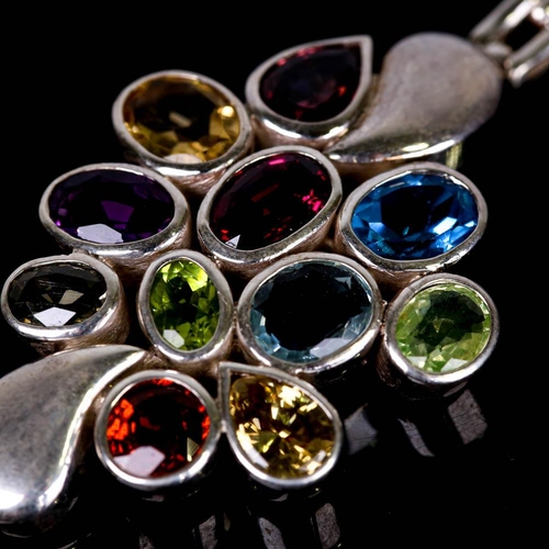 655 - A modern handmade silver gem-set bracelet, gemstones include blue topaz, garnet, amethyst, peridot, ... 