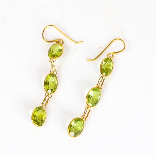 661 - A pair of modern handmade 14ct gold peridot drop earrings, set with oval mixed cut peridot with shep... 