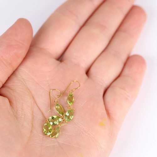 661 - A pair of modern handmade 14ct gold peridot drop earrings, set with oval mixed cut peridot with shep... 