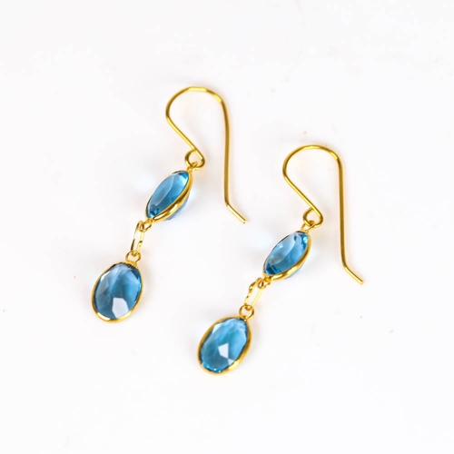 662 - A pair of modern handmade 14ct gold blue topaz drop earrings, set with oval mixed cut topaz and shep... 