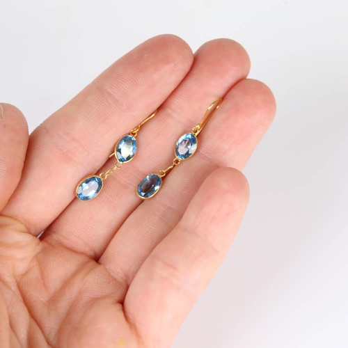 662 - A pair of modern handmade 14ct gold blue topaz drop earrings, set with oval mixed cut topaz and shep... 