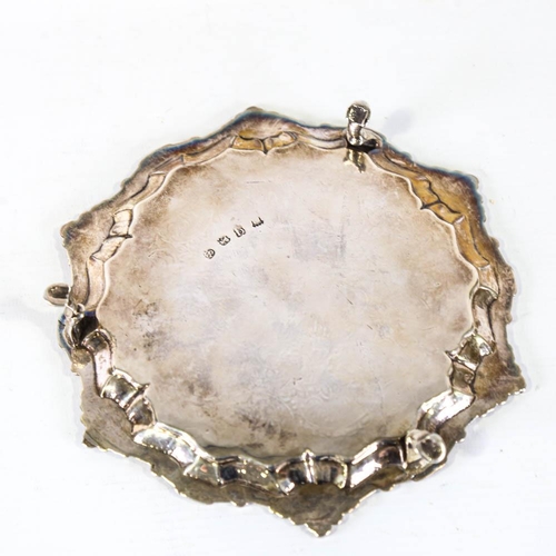 669 - A George II silver salver, circular form with foliate border and floral engraved centre, on 3 feet, ... 