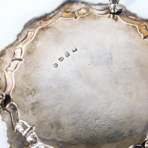 669 - A George II silver salver, circular form with foliate border and floral engraved centre, on 3 feet, ... 