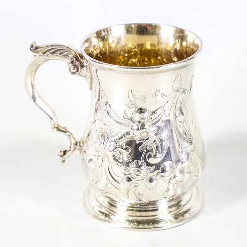 674 - *WITHDRAWN* A George II silver pint mug / tankard, relief embossed floral decoration with scrolled a... 