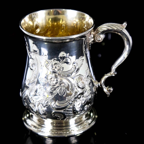 674 - *WITHDRAWN* A George II silver pint mug / tankard, relief embossed floral decoration with scrolled a... 