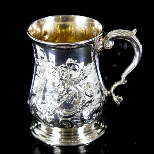 674 - *WITHDRAWN* A George II silver pint mug / tankard, relief embossed floral decoration with scrolled a... 