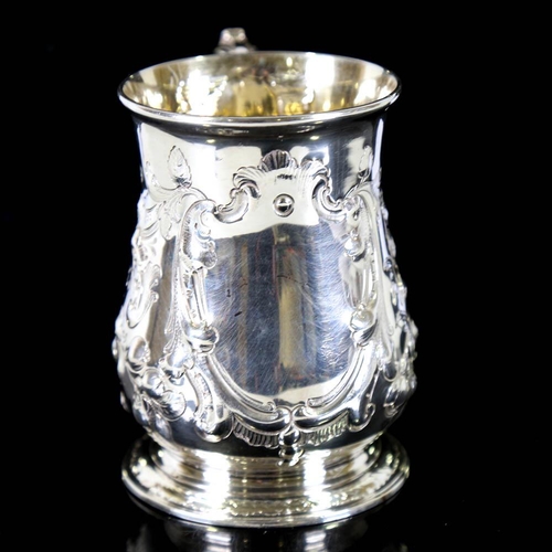 674 - *WITHDRAWN* A George II silver pint mug / tankard, relief embossed floral decoration with scrolled a... 