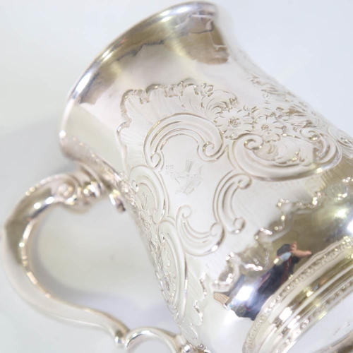 675 - *WITHDRAWN* A George II silver pint mug / tankard, relief embossed foliate decoration with scrolled ... 