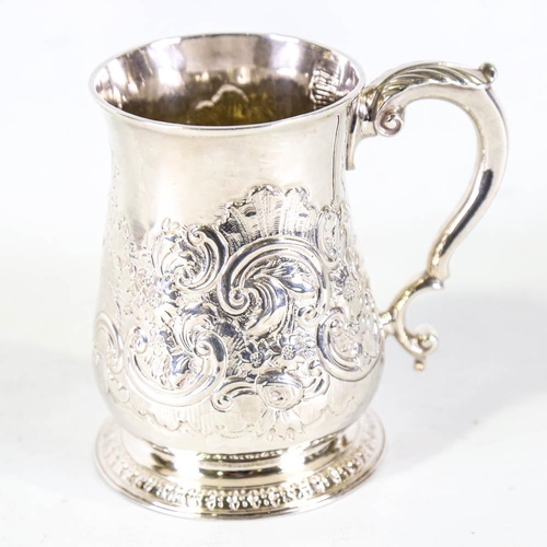 675 - *WITHDRAWN* A George II silver pint mug / tankard, relief embossed foliate decoration with scrolled ... 